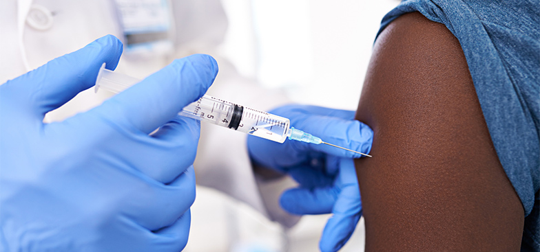 a doctor injects a needle into an arm