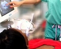 a woman looks at a ultrasound